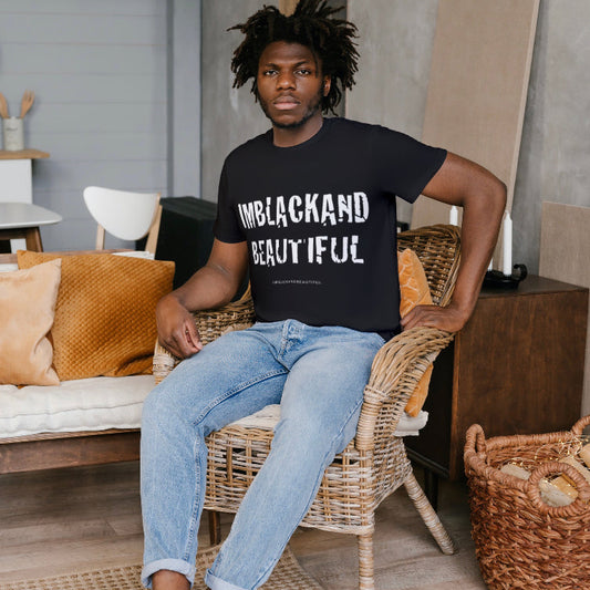 Person wearing a black t-shirt with 'UNBLACKAND BEAUTIFUL' text, sitting in a room with a couch and decor.