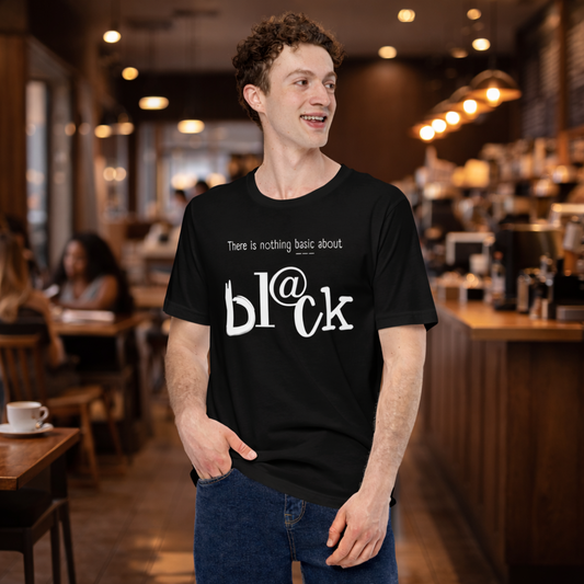 Man wearing a black t-shirt with white text in a coffee shop