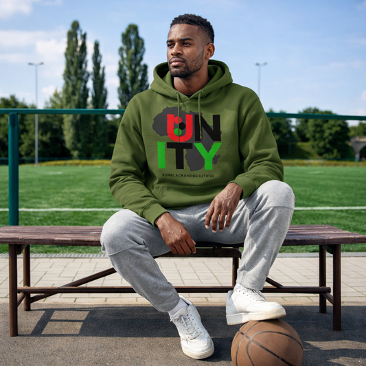 Man sitting on a bench wearing a green hoodie with 'UNITY' printed on it, outdoors.