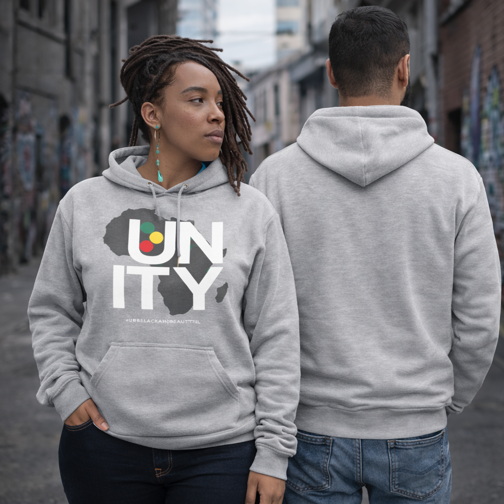 Two people wearing gray hoodies with 'UNITY' design on a street.