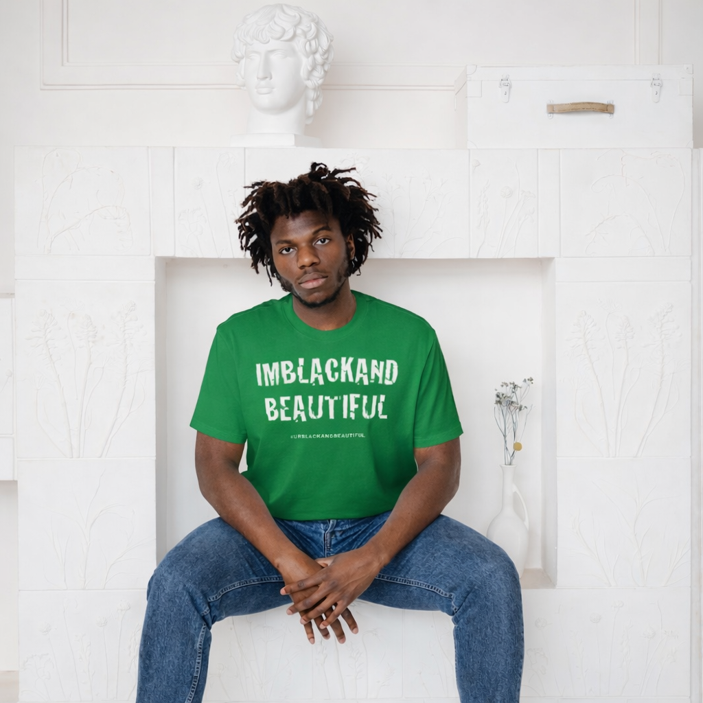 Person wearing a Kelly green t-shirt with 'IMBLACKAND BEAUTIFUL' text, sitting against a white wall.