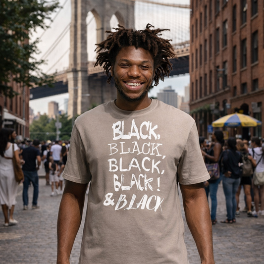 Black man wearing a pebble color  t-shirt with the Brooklyn Bridge in the background.